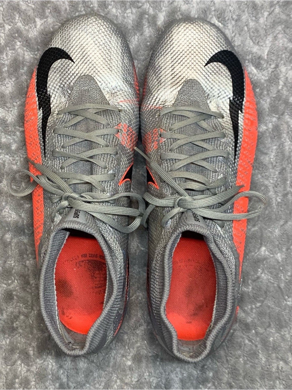 Nike Gray and Orange Soccer Cleats with Black Swoosh